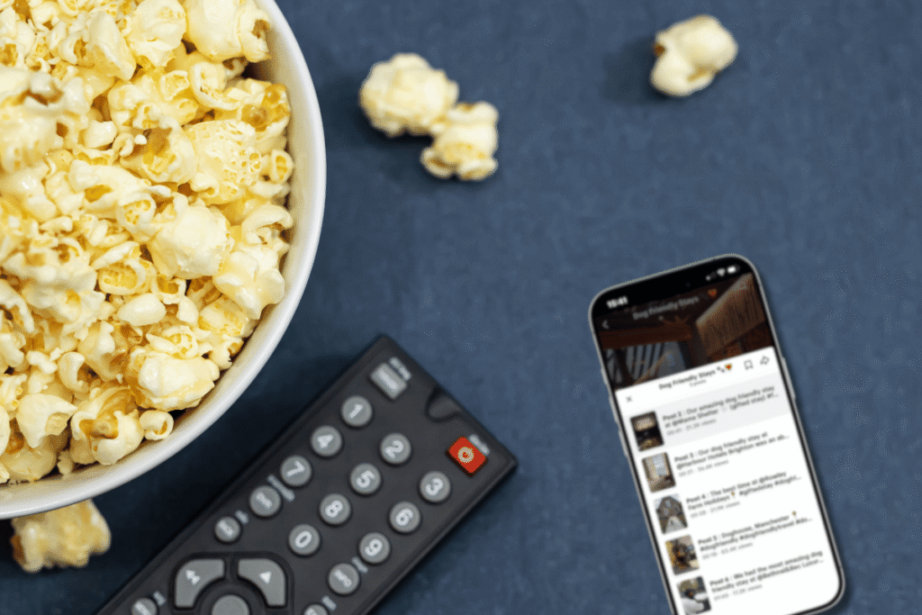 Current Social Media Trends: Four Shifts Businesses Can't Ignore in 2026 4 A mobile phone displaying TikTok series content, next to a remote and bowl of popcorn
