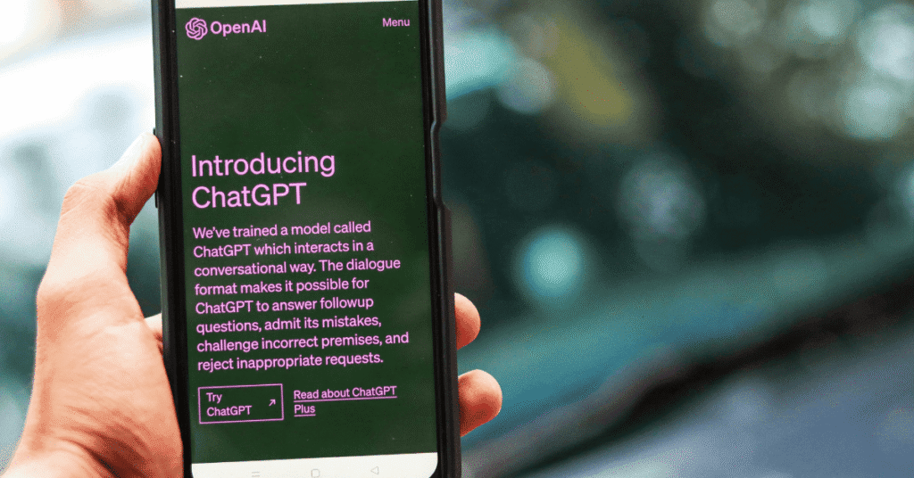 The Role of Ethics in Digital Marketing: Balancing Profit and Responsibility 4 A phone looking at chat gpt, text on the screen shows "Introducing ChatGPT"