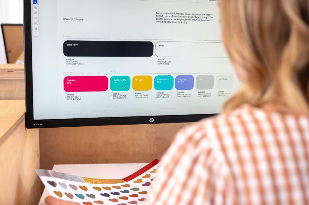 Designer looking at Solve's colour palette for bold UX accessible design
