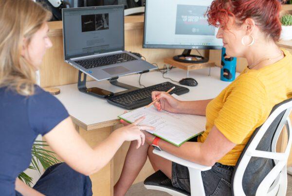 SEO Content Creation That Connects Users and Search Engines 1 SEO content creation meeting between two staff members in Solve's office