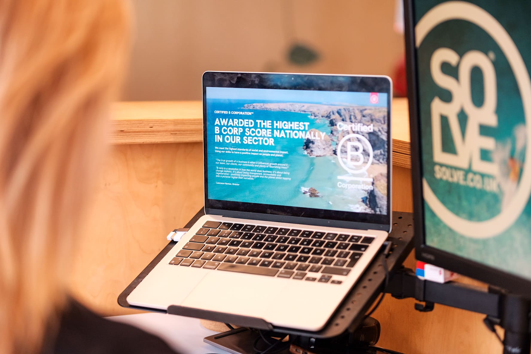 The Real Benefits of Entering Industry Awards 1 Benefits of entering industry awards. An over the shoulder view of a girl looking at Solves B-corp award.