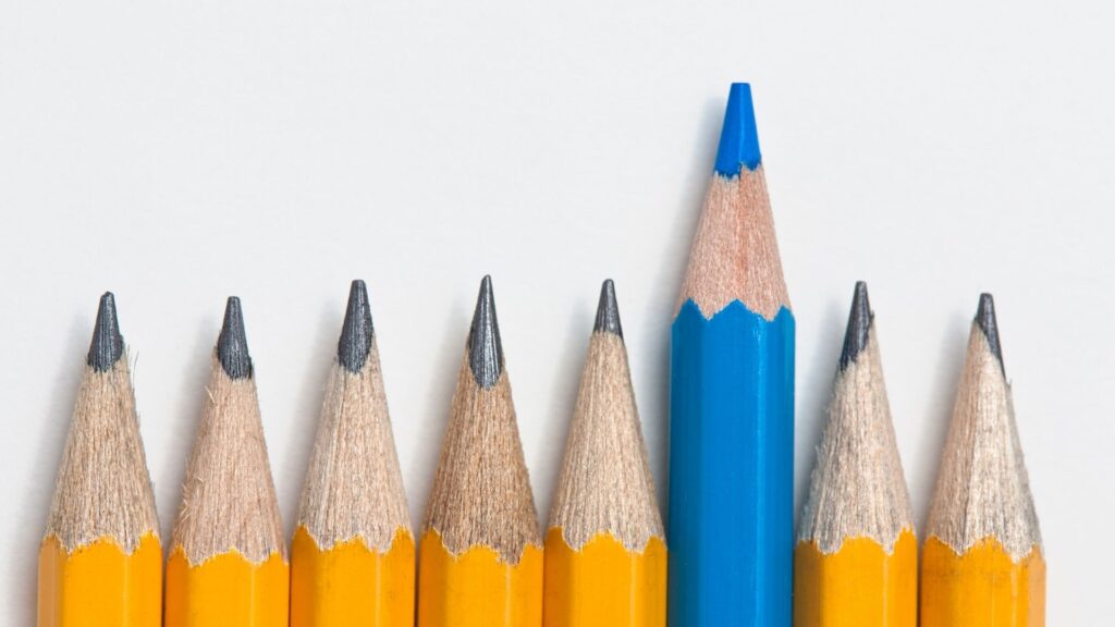 The Real Benefits of Entering Industry Awards 3 a row of yellow coloured lead pencils with one blue colouring pencil sticking out the line above the rest.