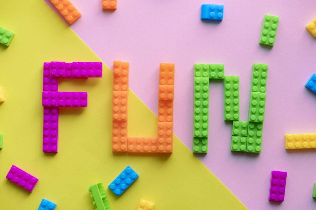 LEGO bricks spelling out the word FUN on a colourful background