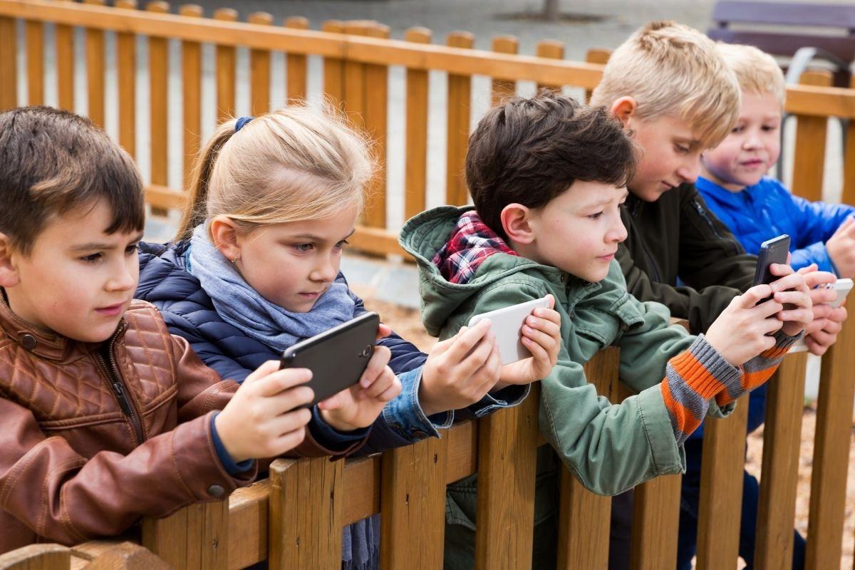 a group of kids holding phones